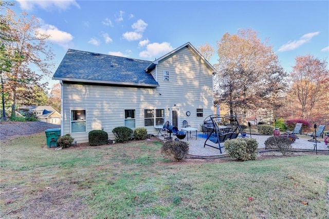 back of house featuring a yard and a patio