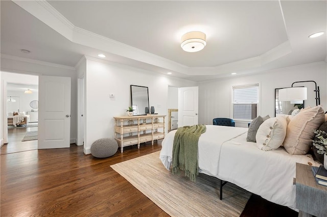 bedroom with recessed lighting, a tray ceiling, dark wood-type flooring, and ornamental molding