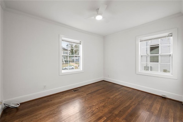 spare room with dark wood-type flooring, ornamental molding, and ceiling fan