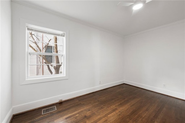 spare room featuring visible vents, dark wood-style floors, crown molding, baseboards, and ceiling fan