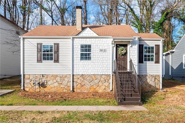 view of front of house featuring crawl space, a chimney, and roof with shingles