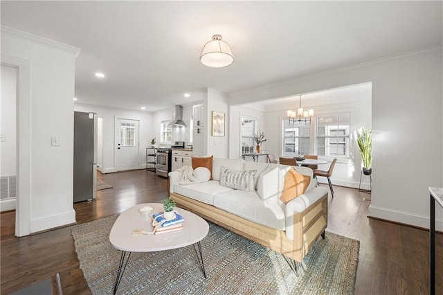 living room featuring crown molding, dark wood-type flooring, and a notable chandelier