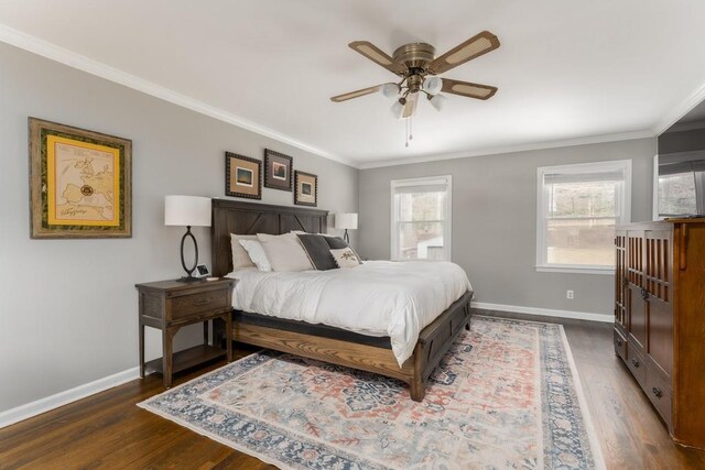 bedroom with crown molding, dark wood-style flooring, and baseboards