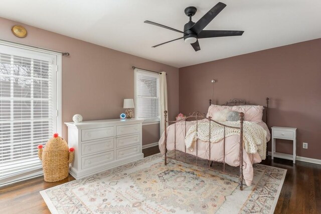 bedroom with a ceiling fan, baseboards, and wood finished floors