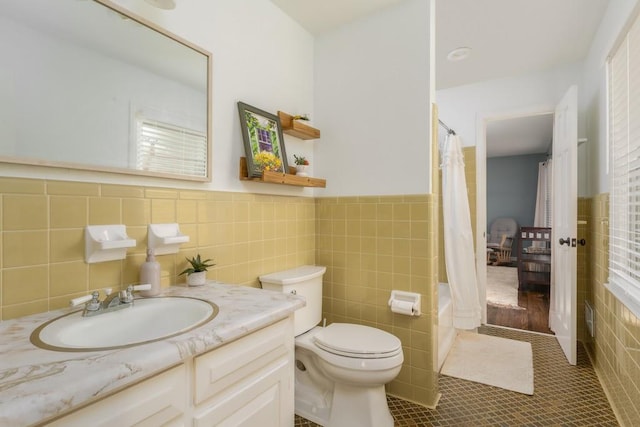 full bathroom featuring tile patterned flooring, toilet, shower / tub combo, vanity, and tile walls