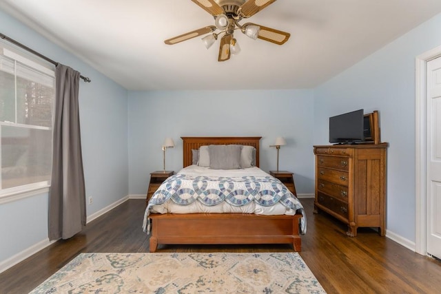 bedroom with ceiling fan, wood finished floors, and baseboards