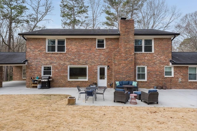 rear view of property with a patio area, a chimney, an outdoor living space, and brick siding