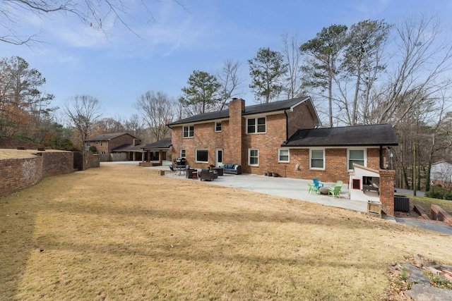 rear view of property with a patio, a chimney, fence, cooling unit, and brick siding