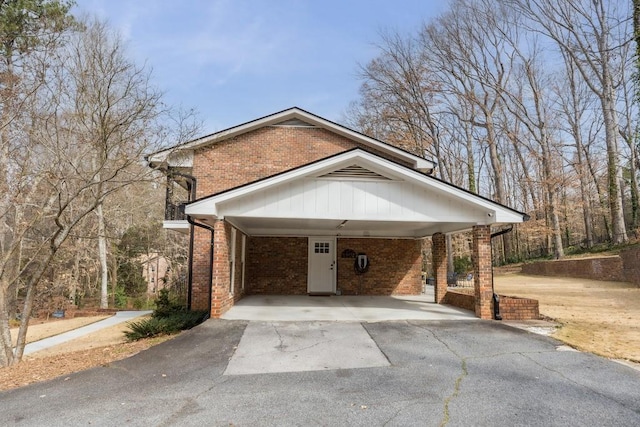 exterior space featuring a carport and aphalt driveway