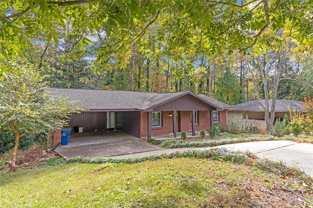 single story home featuring a carport and a front lawn