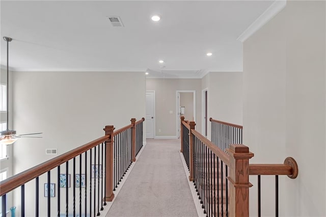 hallway featuring visible vents, an upstairs landing, ornamental molding, light carpet, and recessed lighting