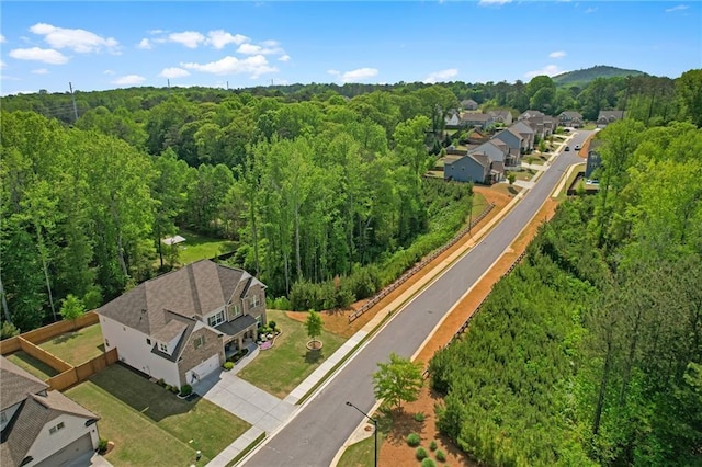 bird's eye view featuring a residential view and a wooded view