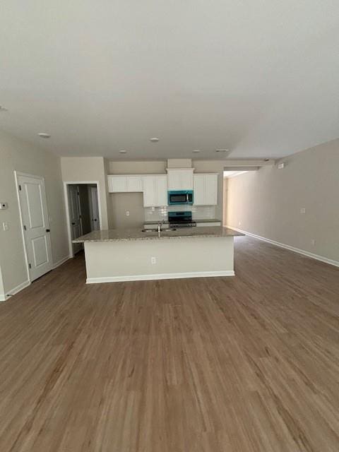 unfurnished living room with dark hardwood / wood-style flooring