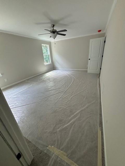 spare room featuring ceiling fan and crown molding