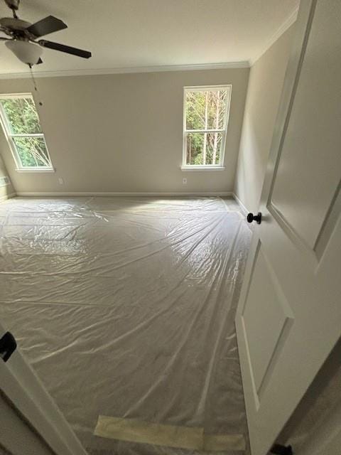 unfurnished bedroom featuring ceiling fan and ornamental molding