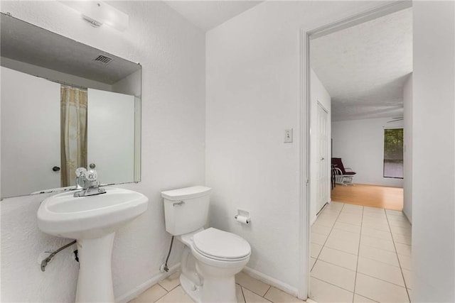 bathroom featuring tile patterned flooring and toilet