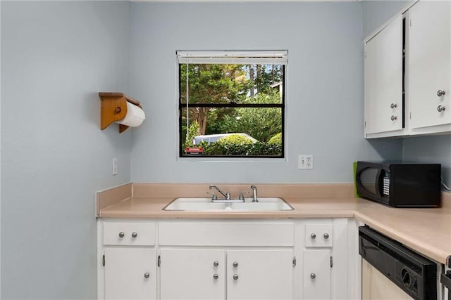 kitchen featuring dishwasher, a sink, black microwave, and light countertops