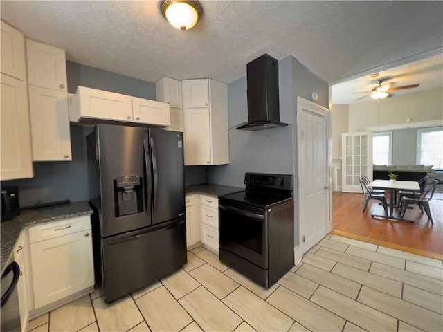 632 Monroe St, Macon, GA 31201 - kitchen with wall chimney range hood, black appliances, white cabinets, a ceiling fan, and a textured ceiling