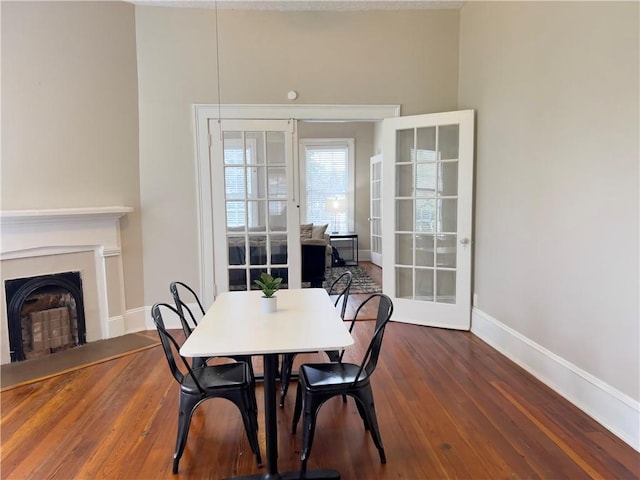632 Monroe St, Macon, GA 31201 - dining space with baseboards, wood finished floors, a fireplace, and french doors