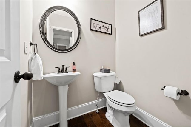 bathroom featuring hardwood / wood-style floors and toilet