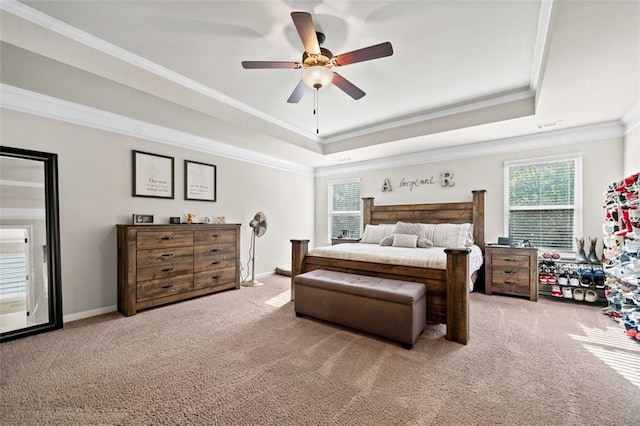 bedroom with carpet floors, a tray ceiling, ceiling fan, and ornamental molding