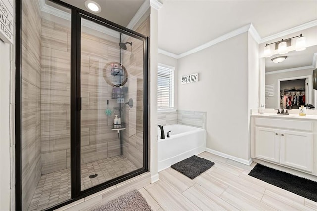 bathroom with separate shower and tub, vanity, and ornamental molding