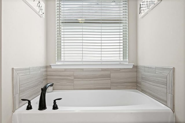 bathroom with a tub to relax in