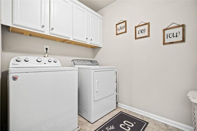 clothes washing area with washer and dryer, light tile patterned floors, and cabinets