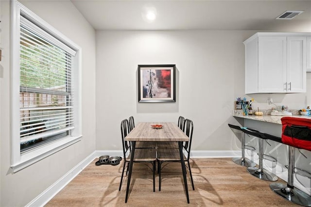 dining area with light hardwood / wood-style floors