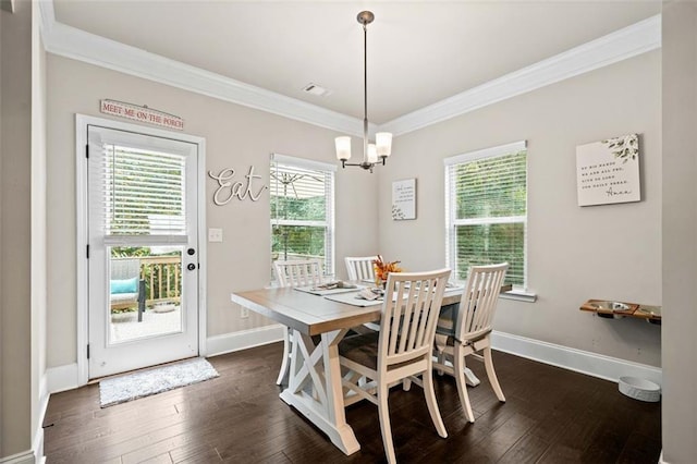 dining room with dark hardwood / wood-style floors, crown molding, and a wealth of natural light