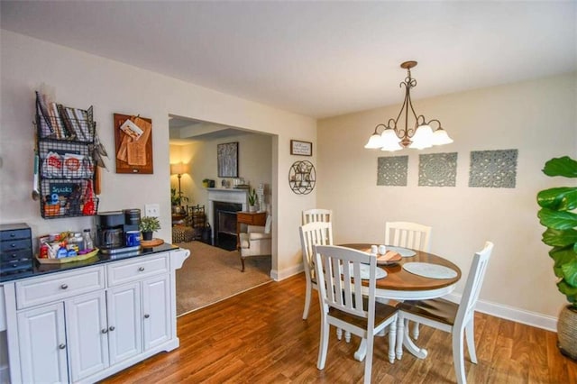 dining space with an inviting chandelier and hardwood / wood-style floors