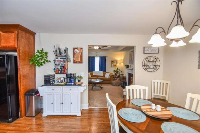 dining area with hardwood / wood-style flooring and a notable chandelier