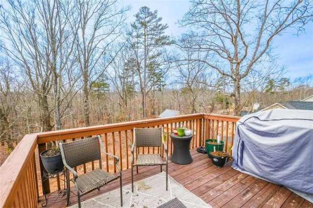 wooden terrace with a grill