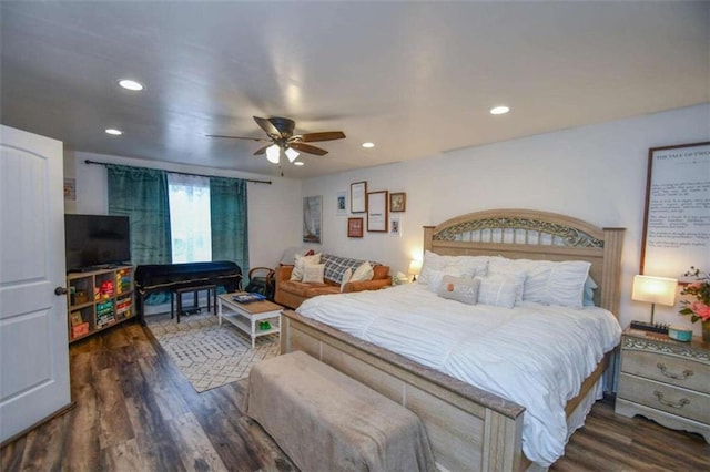 bedroom with dark hardwood / wood-style flooring and ceiling fan