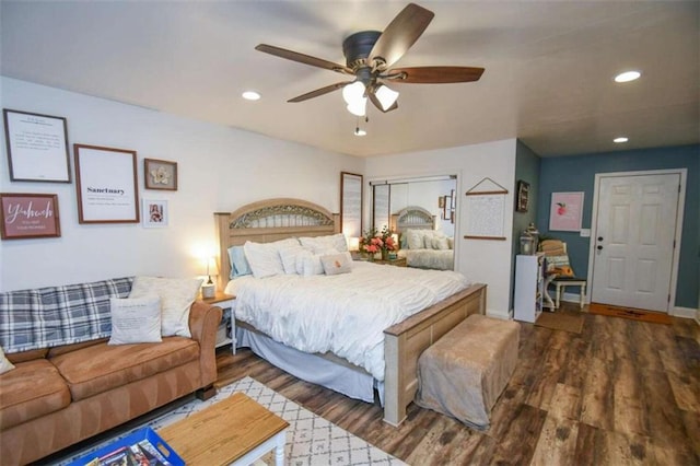 bedroom with dark hardwood / wood-style floors and ceiling fan