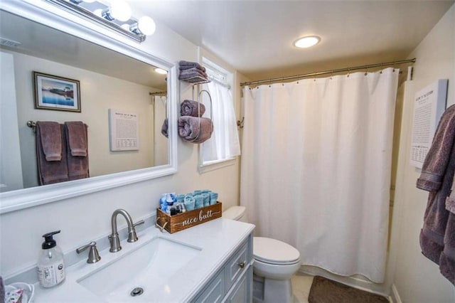 bathroom featuring a shower with curtain, vanity, tile patterned floors, and toilet