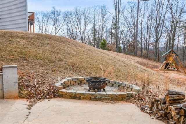 view of yard with a playground and a fire pit