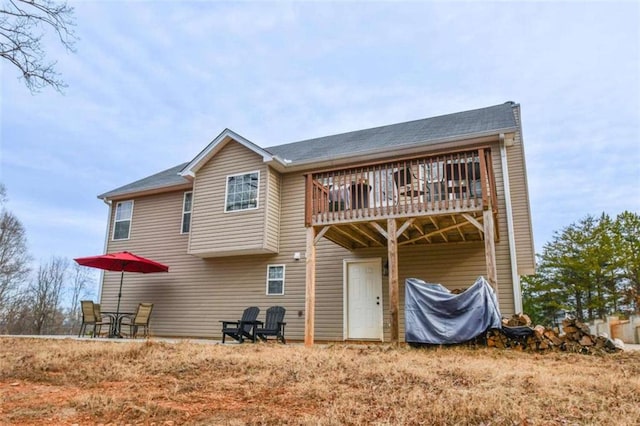 rear view of house with a wooden deck