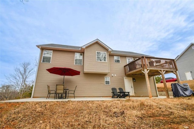 back of property featuring a patio area and a deck