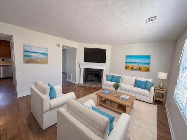 living room with hardwood / wood-style floors and a textured ceiling