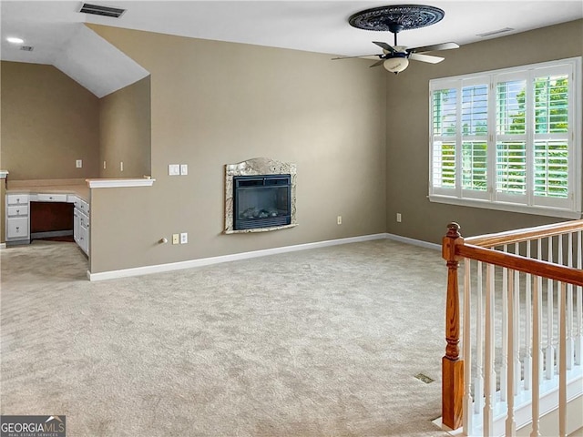 unfurnished living room with a premium fireplace, visible vents, and light carpet