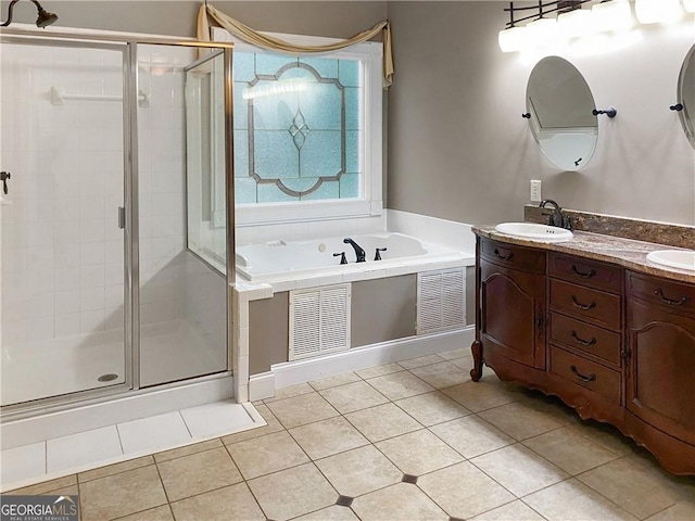 bathroom with a sink, visible vents, a stall shower, and tile patterned flooring