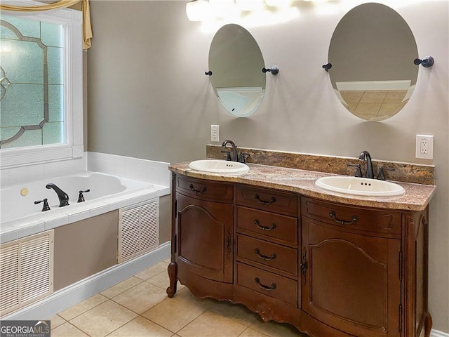 bathroom featuring tile patterned floors, a bath, double vanity, and a sink