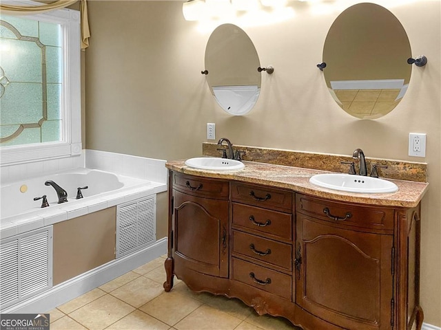 bathroom with a sink, visible vents, a bath, and tile patterned flooring