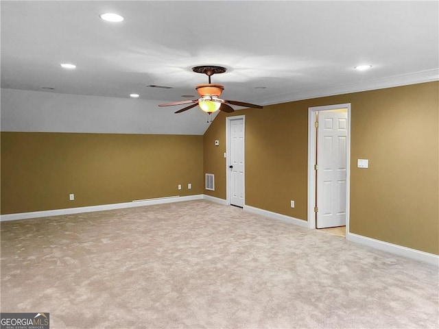 interior space with baseboards, lofted ceiling, light carpet, and ceiling fan