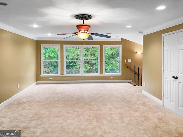 carpeted spare room with a ceiling fan, crown molding, recessed lighting, and baseboards