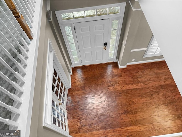 foyer featuring baseboards and wood finished floors