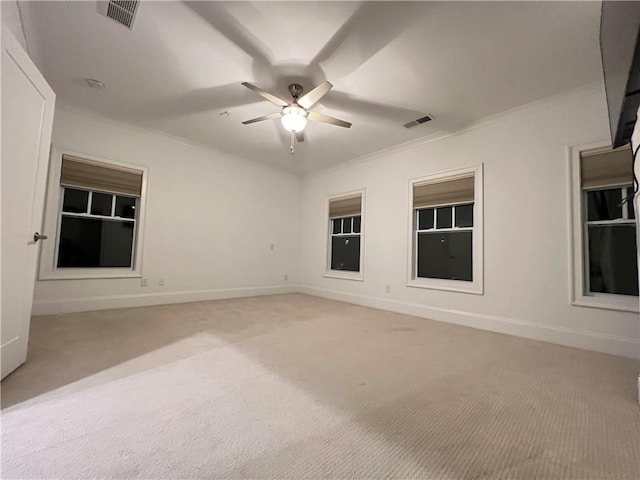 carpeted empty room with ceiling fan and ornamental molding