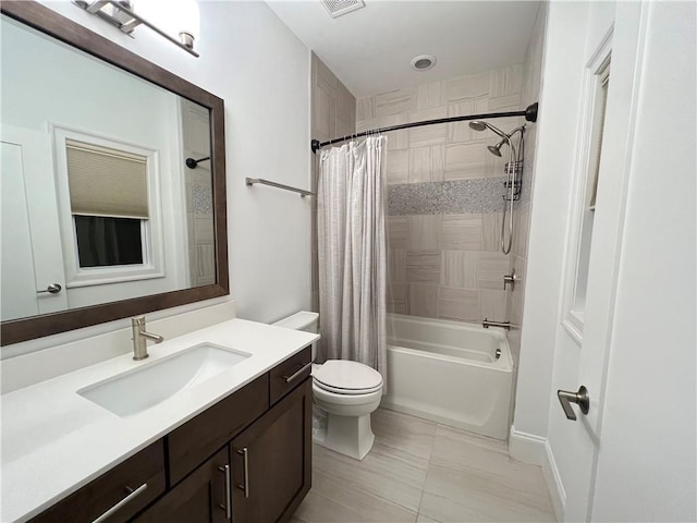 full bathroom featuring tile patterned floors, vanity, toilet, and shower / bath combo with shower curtain