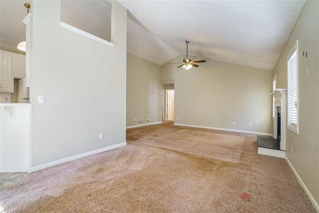 unfurnished living room featuring high vaulted ceiling, light colored carpet, and ceiling fan